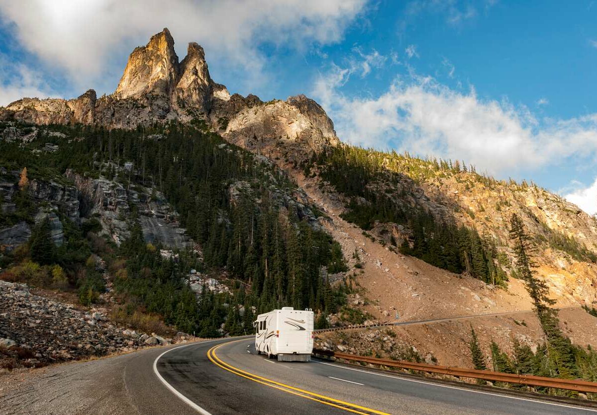 An RV driving by Liberty Bell Mountain along the North Cascades Highway in Washington state.