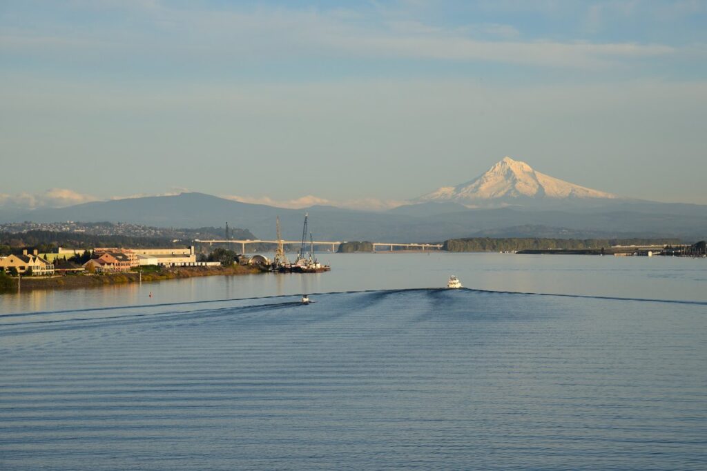 A view of Mount Hood from the serene Columbia River at dawn.